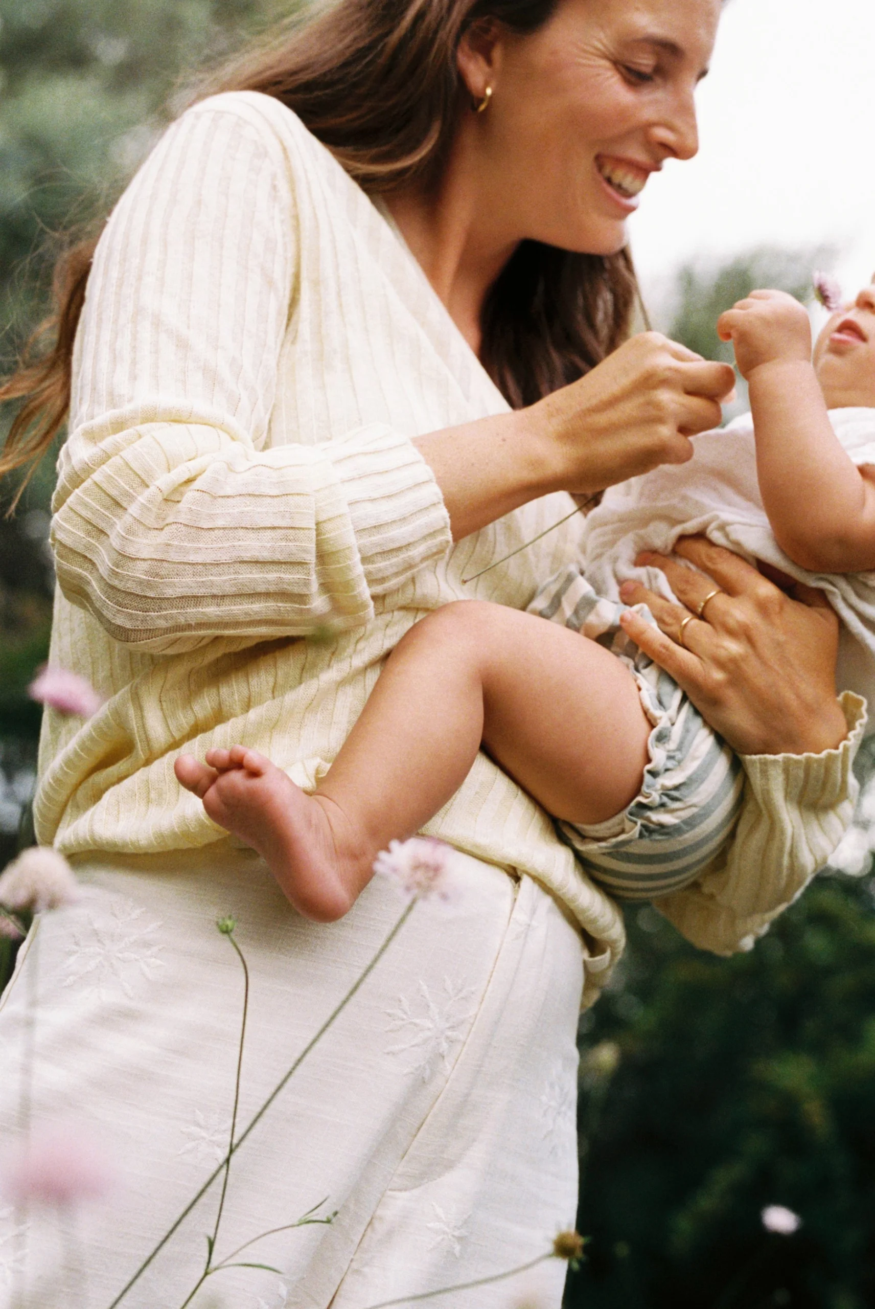 Retrato en fotografía analógica de una madre con su bebé durante una sesión familiar